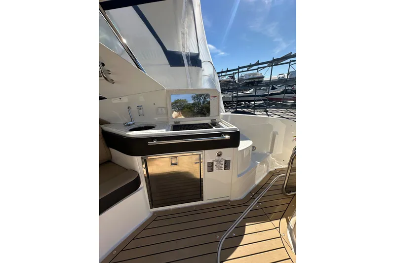  Yacht Photos Pics 2020 Sea Ray Sundancer 320 yacht interior with kitchenette and seating area.