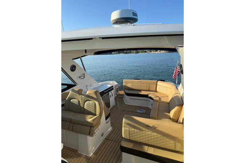  Yacht Photos Pics 2020 Sea Ray Sundancer 320 yacht interior with tan seating, overlooking serene water.