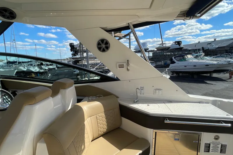  Yacht Photos Pics Interior of 2020 Sea Ray Sundancer 320 yacht with seating and kitchenette, docked at marina.