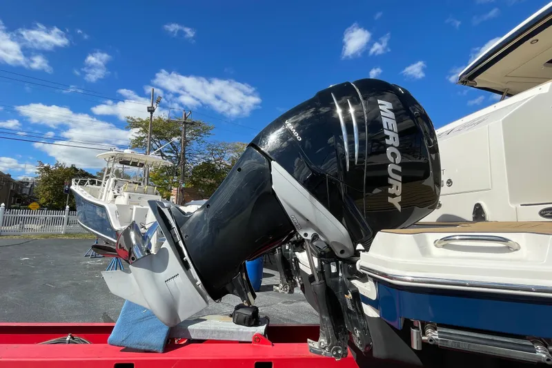  Yacht Photos Pics 2020 Sea Ray Sundancer 320 with Mercury outboard motor under clear blue sky.