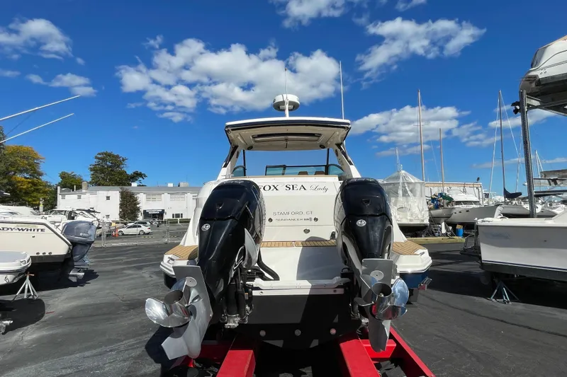  Yacht Photos Pics 2020 Sea Ray Sundancer 320 boat with dual outboard motors on a sunny day.