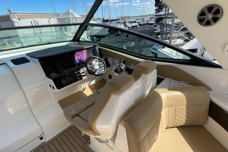  Yacht Photos Pics 2020 Sea Ray Sundancer 320 helm with modern controls and beige seating, docked at marina.
