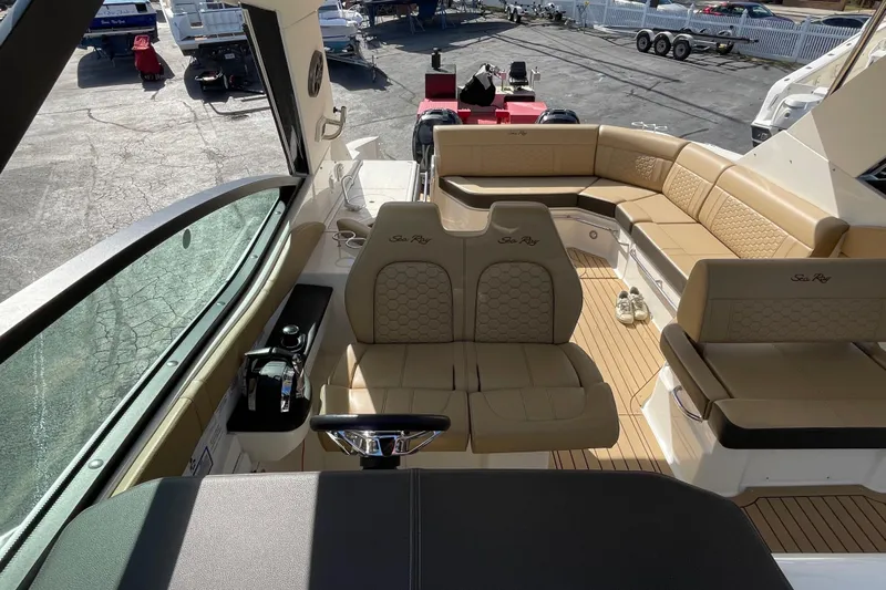  Yacht Photos Pics 2020 Sea Ray Sundancer 320 interior with tan seating and helm, docked at marina.