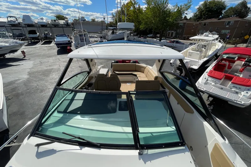  Yacht Photos Pics 2020 Sea Ray Sundancer 320 boat with open deck and seating, docked in a marina.