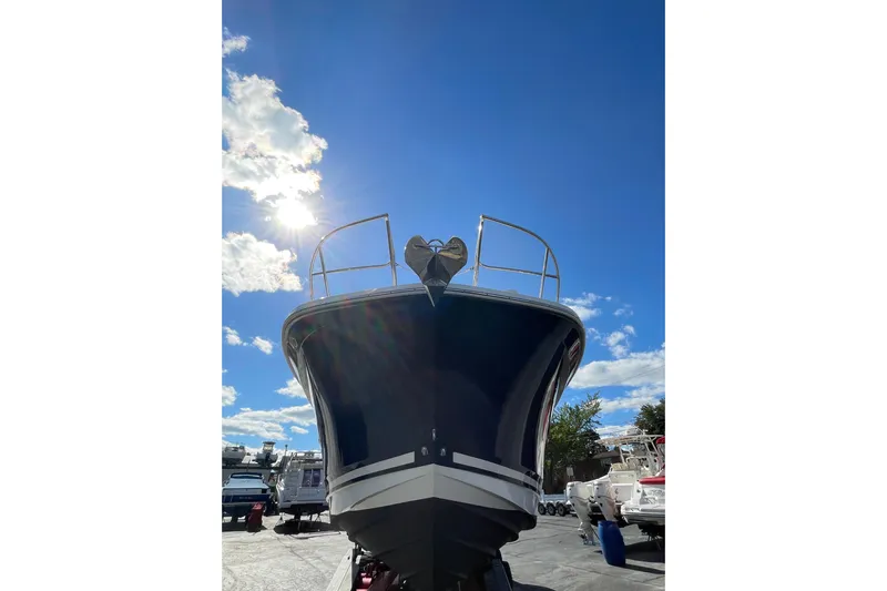  Yacht Photos Pics 2020 Sea Ray Sundancer 320 boat under bright blue sky with sun and clouds.