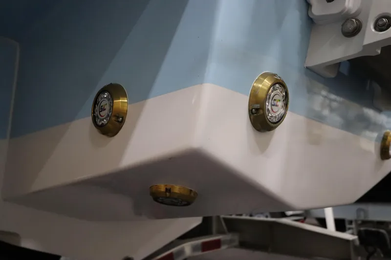  Yacht Photos Pics 2024 SeaCraft 23CC boat hull with brass fittings and blue-white color scheme.