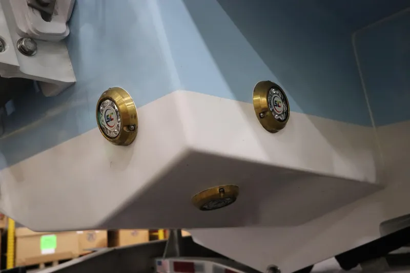  Yacht Photos Pics 2024 SeaCraft 23CC boat hull with brass fittings, close-up view.