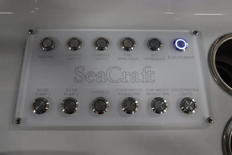  Yacht Photos Pics Control panel of 2024 SeaCraft 23CC boat with labeled buttons for various functions.
