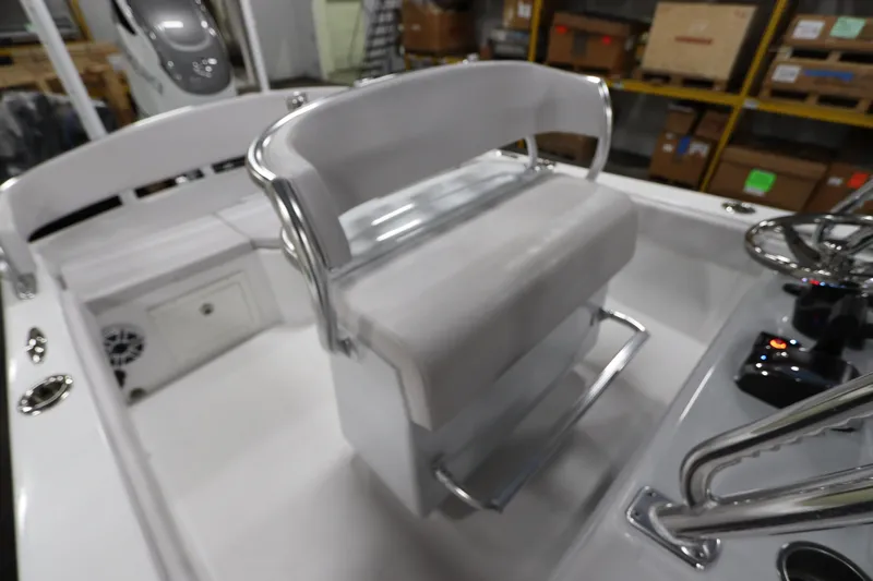  Yacht Photos Pics 2024 SeaCraft 23CC boat interior with white seating and steering console.