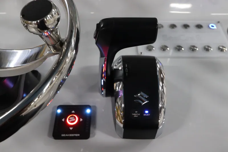  Yacht Photos Pics 2024 SeaCraft 23CC boat controls with steering wheel and throttle system.