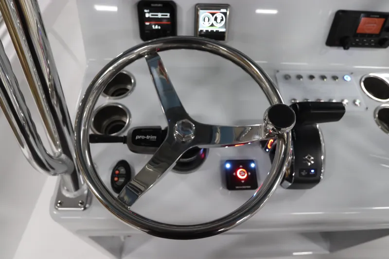  Yacht Photos Pics 2024 SeaCraft 23CC boat dashboard with steering wheel and control panel.