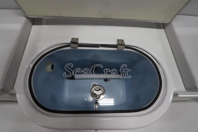  Yacht Photos Pics 2024 SeaCraft 23CC livewell with logo, featuring a secure latch and sleek design.