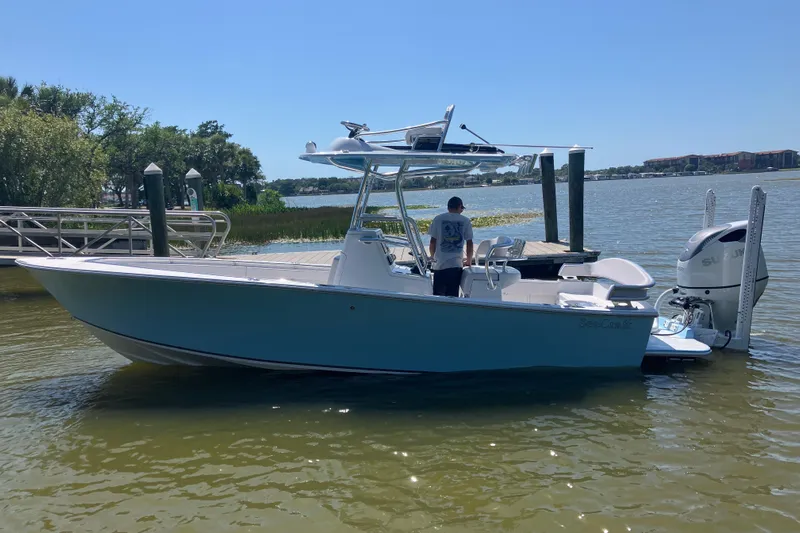  Yacht Photos Pics 2024 SeaCraft 23CC boat docked on a sunny day, featuring sleek design and powerful engine.