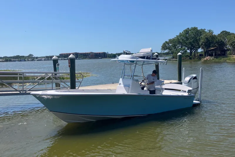  Yacht Photos Pics 2024 SeaCraft 23CC boat docked on a sunny day by the water.