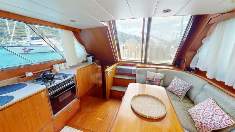 Aurora Of St.vincent Yacht Photos Pics Cozy interior of 2000 Horizon 48 yacht with kitchen and seating area.