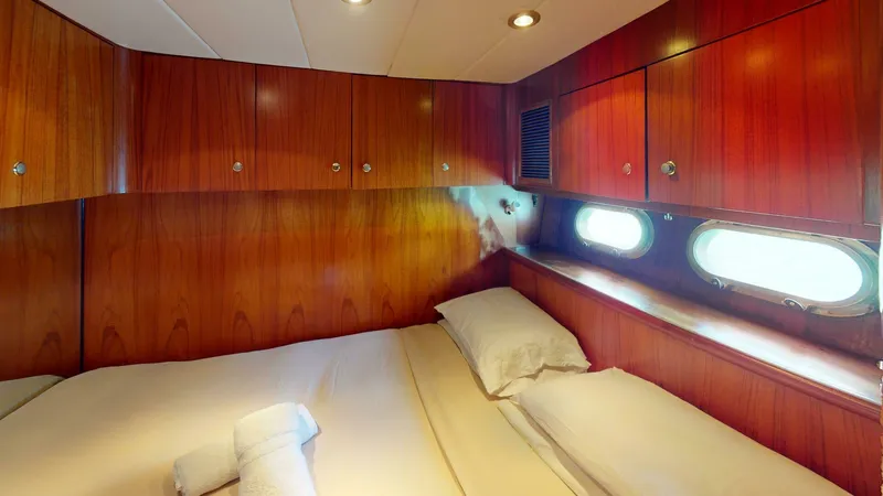 Aurora Of St.vincent Yacht Photos Pics Cozy cabin interior of 2000 Horizon 48 yacht with wooden paneling and porthole windows.
