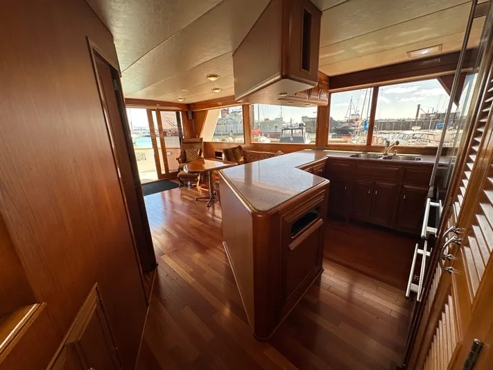  Yacht Photos Pics Interior of 1985 Ocean Alexander Pilothouse yacht with wooden flooring and spacious kitchen area.