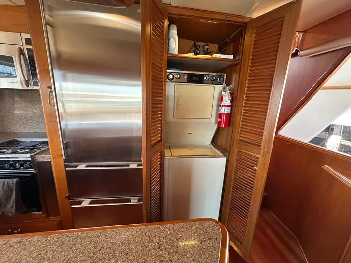  Yacht Photos Pics 1985 Ocean Alexander Pilothouse interior with stainless steel appliances and wooden cabinetry.