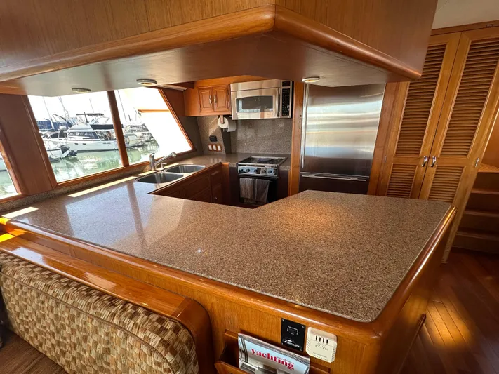  Yacht Photos Pics Luxurious kitchen interior of 1985 Ocean Alexander Pilothouse yacht with modern appliances.