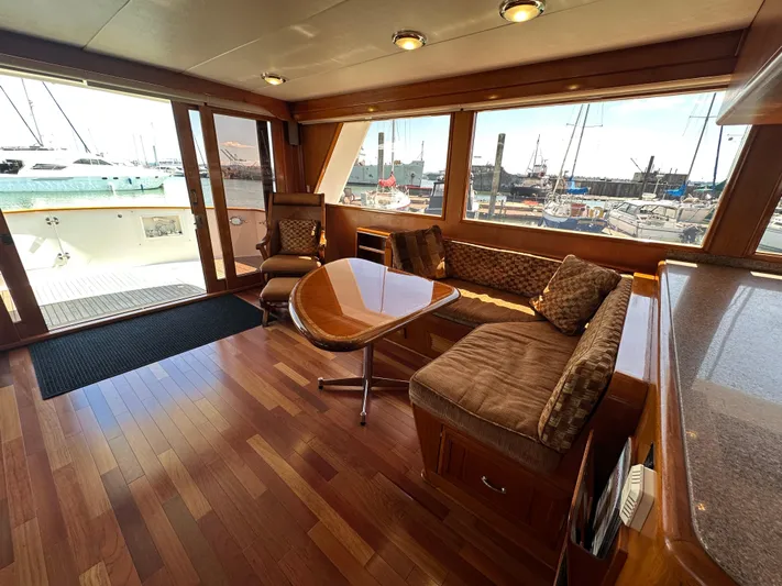  Yacht Photos Pics Luxurious 1985 Ocean Alexander Pilothouse interior with wood flooring and marina view.