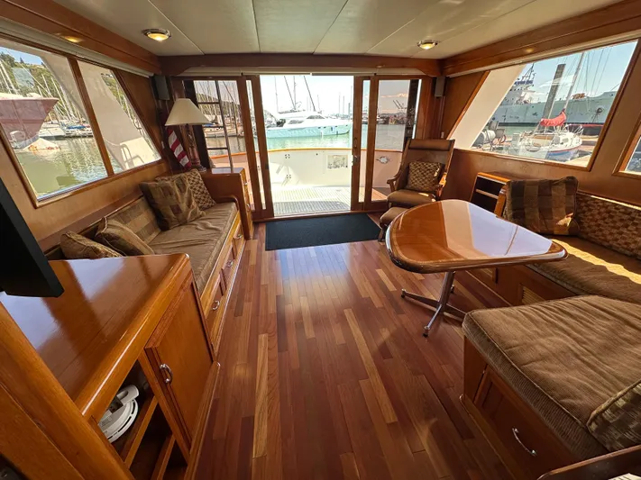  Yacht Photos Pics Luxurious interior of 1985 Ocean Alexander Pilothouse yacht with wood flooring and plush seating.