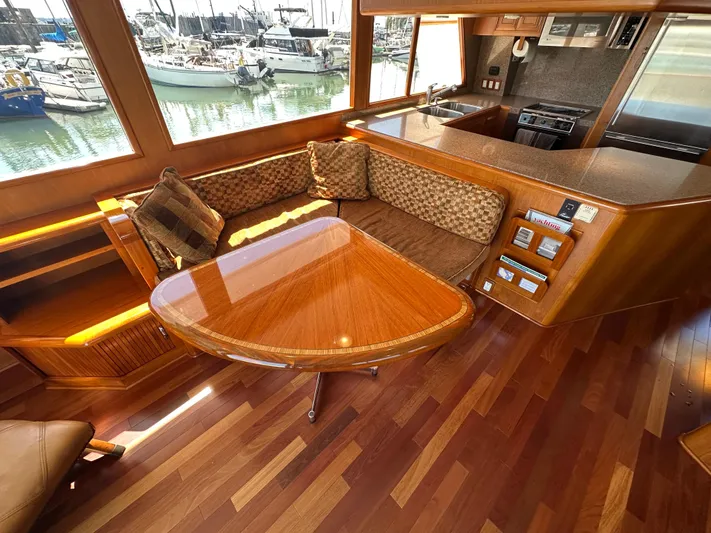  Yacht Photos Pics Luxurious 1985 Ocean Alexander Pilothouse interior with wood finishes and marina view.