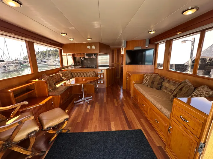  Yacht Photos Pics Luxurious 1985 Ocean Alexander Pilothouse interior with wood finishes and comfortable seating.