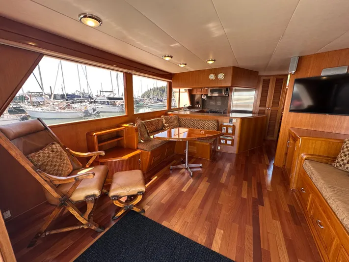  Yacht Photos Pics Luxurious 1985 Ocean Alexander Pilothouse interior with wood finishes and marina view.