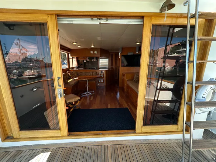  Yacht Photos Pics 1985 Ocean Alexander Pilothouse interior with wooden flooring, kitchen, and seating area.