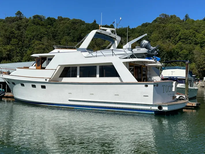  Yacht Photos Pics 1985 Ocean Alexander Pilothouse yacht docked in a serene marina setting.