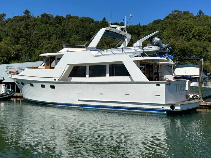 Yacht Photos Pics 1985 Ocean Alexander Pilothouse yacht docked in a serene marina setting.