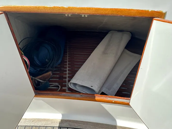  Yacht Photos Pics Storage compartment on 1985 Ocean Alexander Pilothouse yacht with coiled cables and rolled fabric.