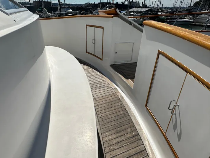  Yacht Photos Pics 1985 Ocean Alexander Pilothouse yacht deck with wooden trim and storage compartments.