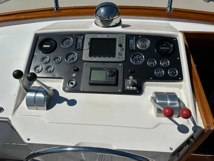  Yacht Photos Pics 1985 Ocean Alexander Pilothouse control panel with gauges, levers, and navigation equipment.