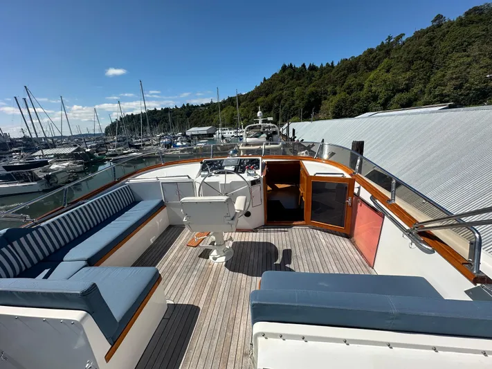  Yacht Photos Pics 1985 Ocean Alexander Pilothouse yacht deck with seating, helm, and marina view.