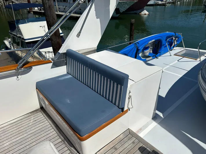  Yacht Photos Pics 1985 Ocean Alexander Pilothouse yacht deck with blue seating and kayak.