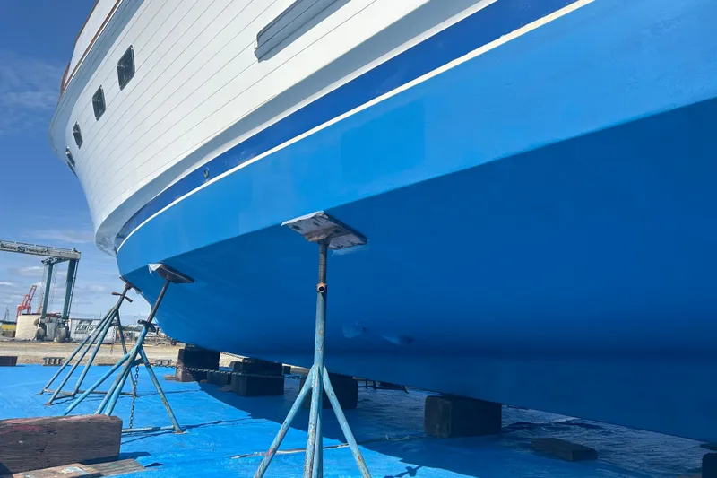  Yacht Photos Pics 1985 Ocean Alexander Pilothouse yacht on stands, blue hull, shipyard setting.