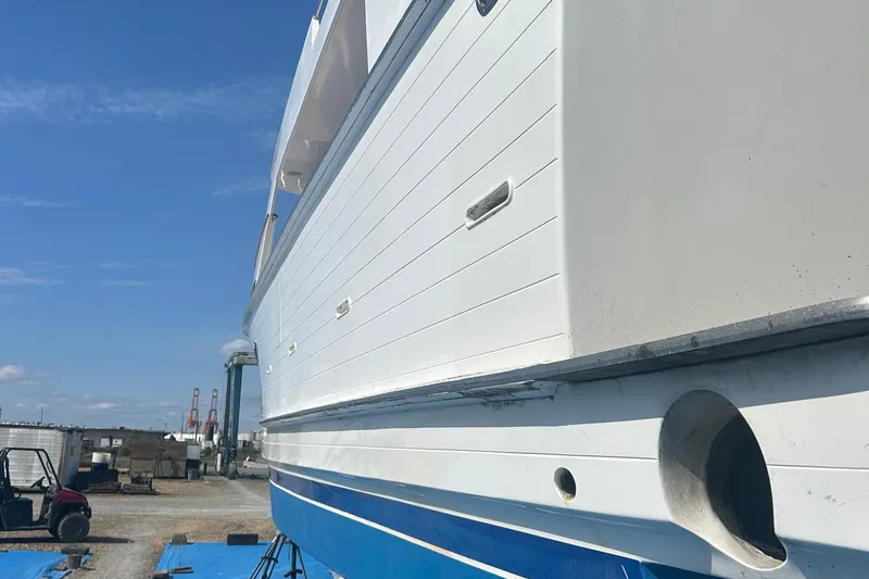  Yacht Photos Pics 1985 Ocean Alexander Pilothouse yacht on dry dock, showcasing white and blue hull.