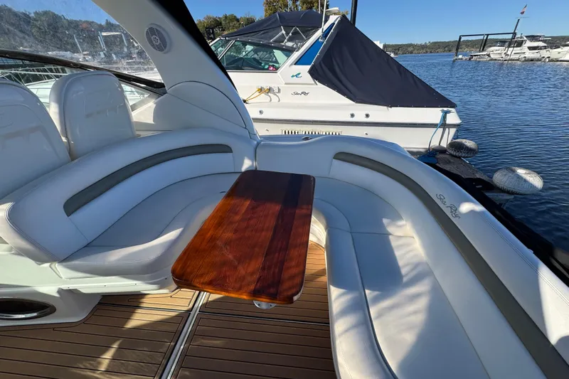  Yacht Photos Pics Luxurious 2007 Sea Ray 340 Sundancer boat interior with curved seating and wooden table.
