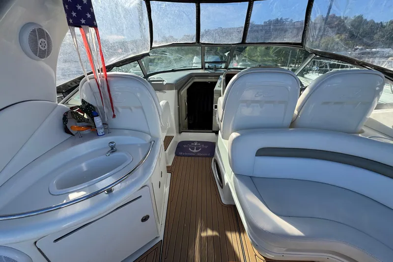  Yacht Photos Pics 2007 Sea Ray 340 Sundancer interior with seating, sink, and American flag.