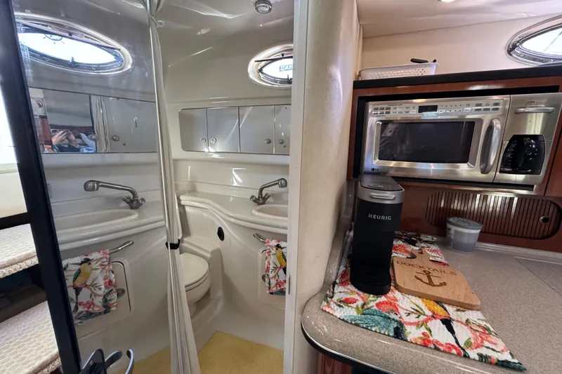  Yacht Photos Pics Interior of 2007 Sea Ray 340 Sundancer with kitchenette and bathroom, featuring modern appliances.