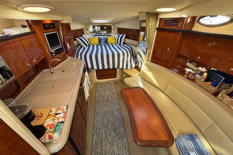  Yacht Photos Pics Luxurious interior of 2007 Sea Ray 340 Sundancer yacht with cozy seating and elegant wood finishes.