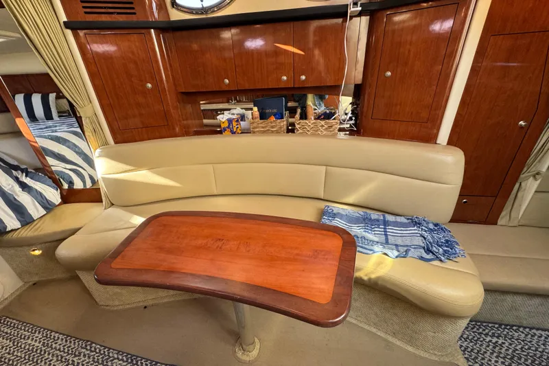  Yacht Photos Pics Luxurious 2007 Sea Ray 340 Sundancer cabin with elegant seating and wooden table.