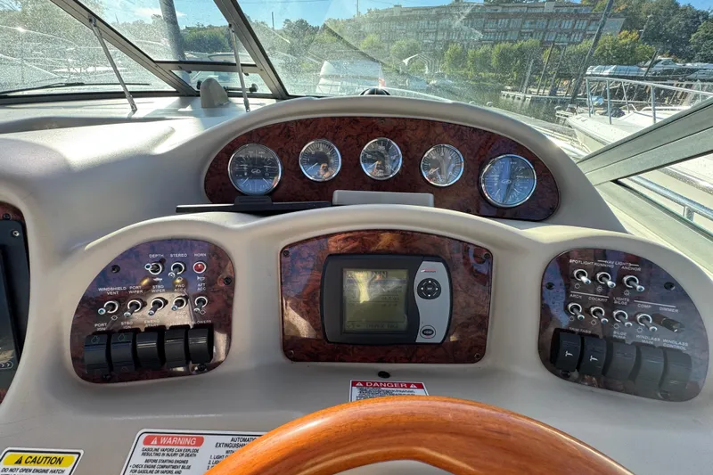  Yacht Photos Pics 2007 Sea Ray 340 Sundancer dashboard with gauges and controls, featuring wood accents and navigation system.