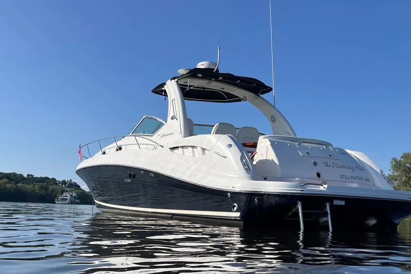  Yacht Photos Pics 2007 Sea Ray 340 Sundancer boat on calm water under clear blue sky.