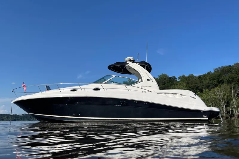  Yacht Photos Pics 2007 Sea Ray 340 Sundancer yacht on calm water under clear blue sky.