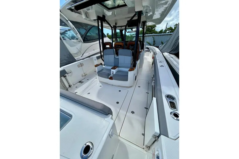  Yacht Photos Pics 2023 Boston Whaler 360 Outrage boat interior with seating and sleek design.