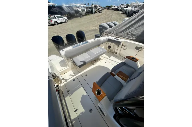  Yacht Photos Pics 2023 Boston Whaler 360 Outrage boat interior with seating and multiple outboard engines.