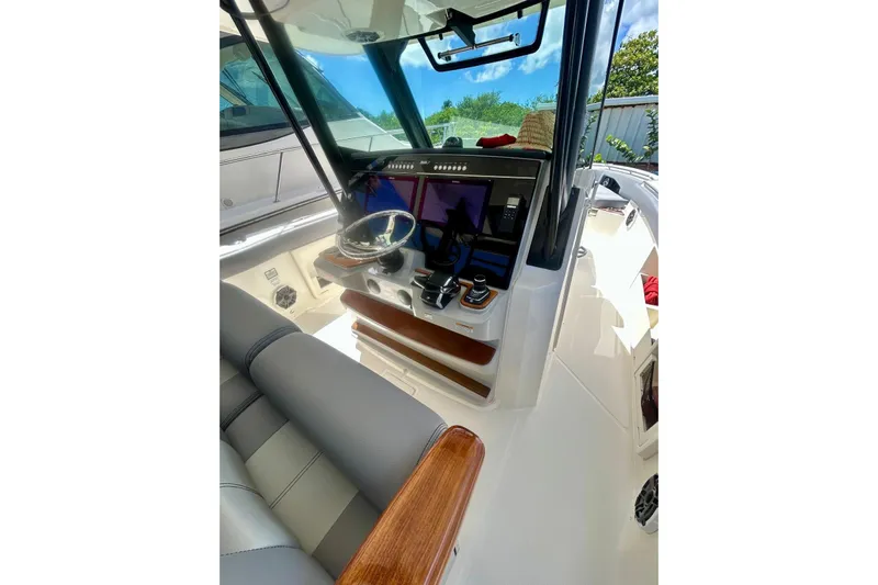  Yacht Photos Pics 2023 Boston Whaler 360 Outrage helm with modern controls and sleek design.