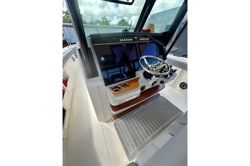  Yacht Photos Pics 2023 Boston Whaler 360 Outrage helm with modern controls and sleek design.